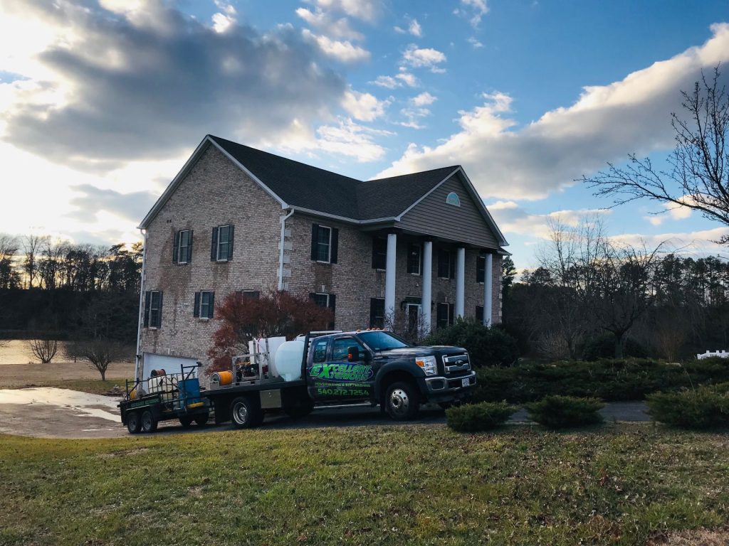 A service company truck of Excellent Exterior LLC is in a residential building located in Fredericksburg.