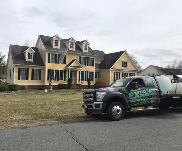 A service company truck and an expert cleaner of Excellent Exterior LLC cleaned a house located in Fredericksburg.